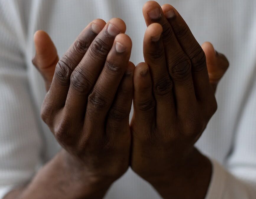 crop black man showing pray gesture
