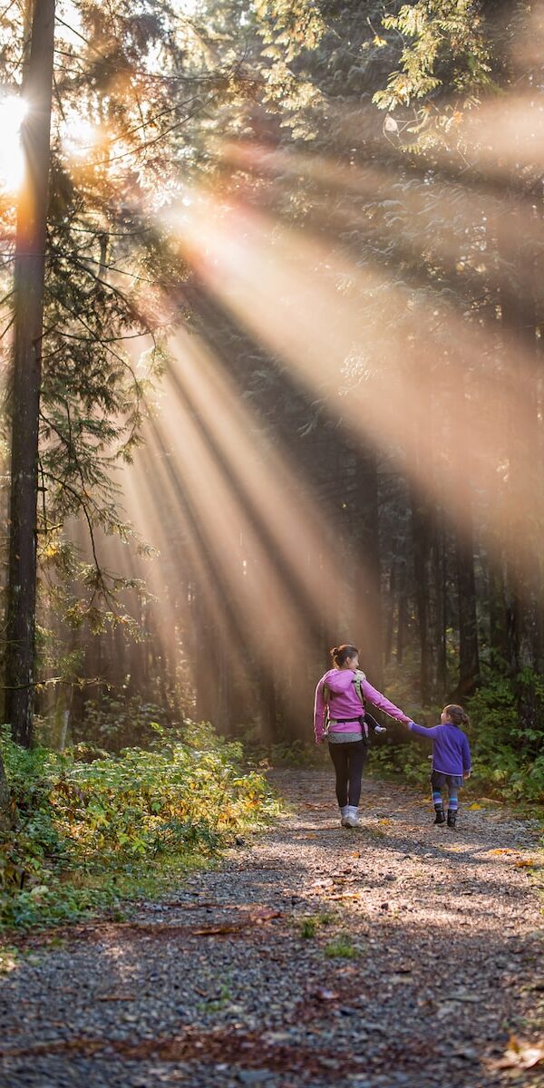 woman walking in forest with child