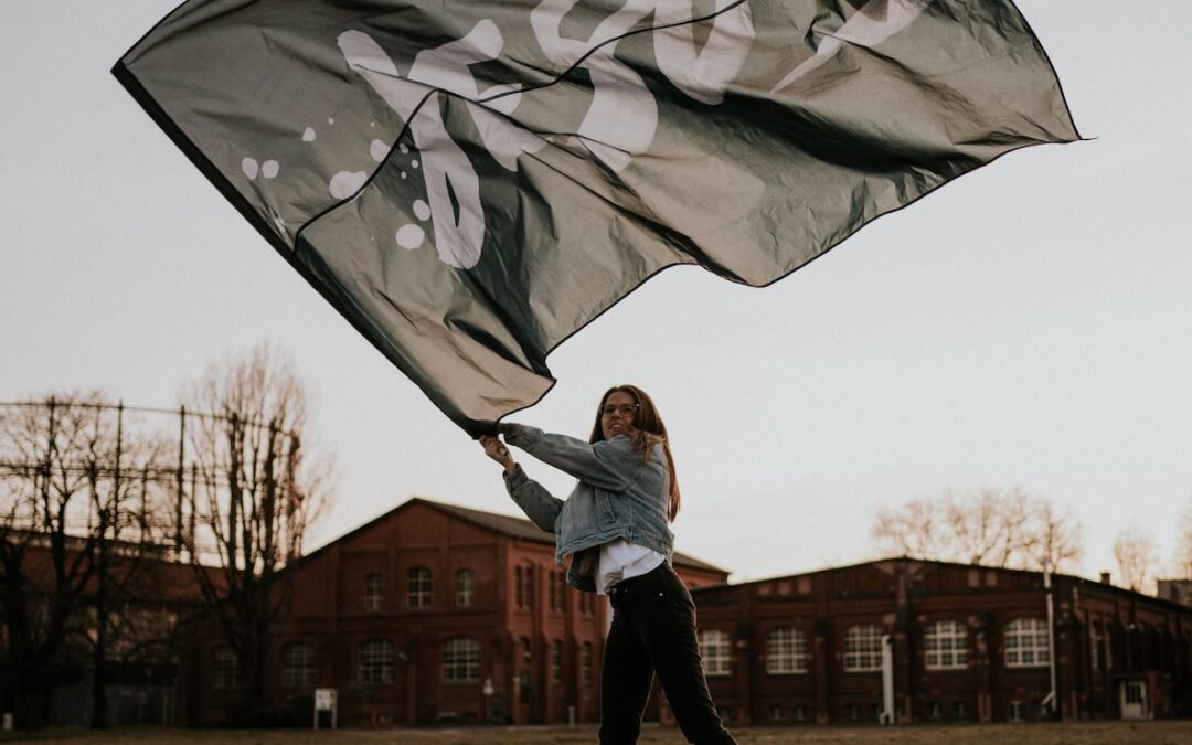 man in white jacket holding umbrella