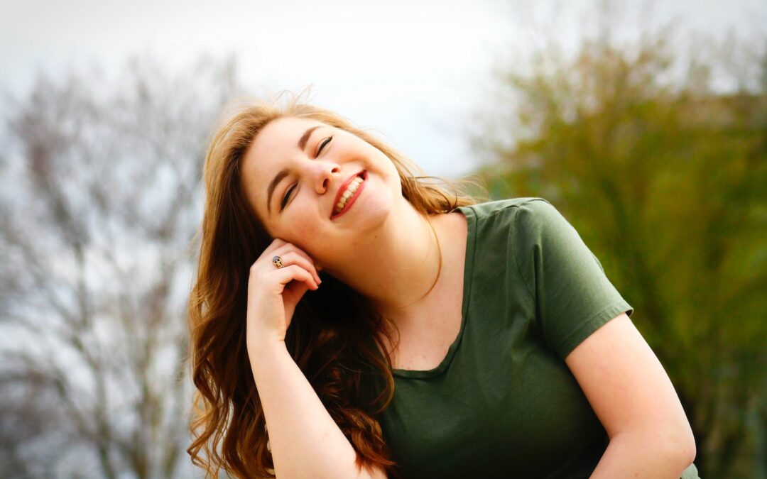 woman in green shirt smiling