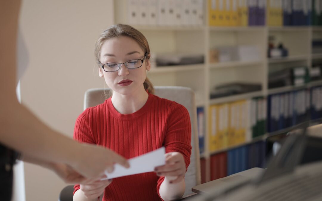 young woman examining document in office