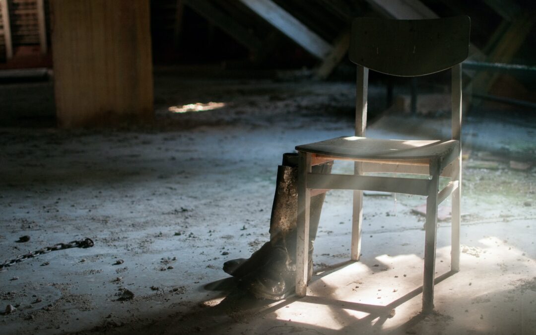 pair of boots beside chair