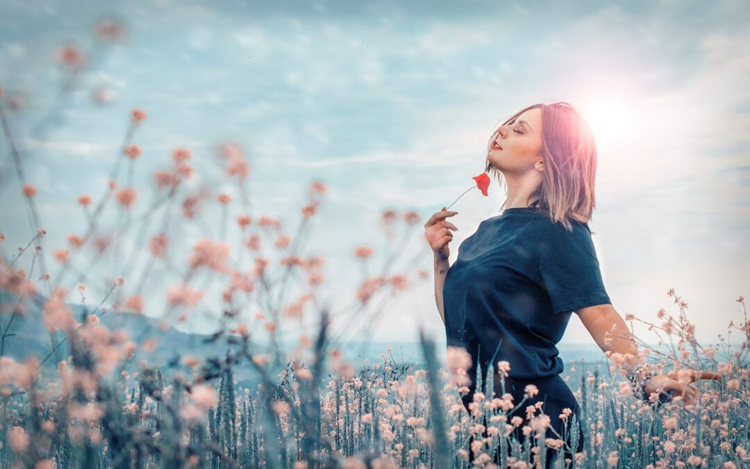woman holding red flower