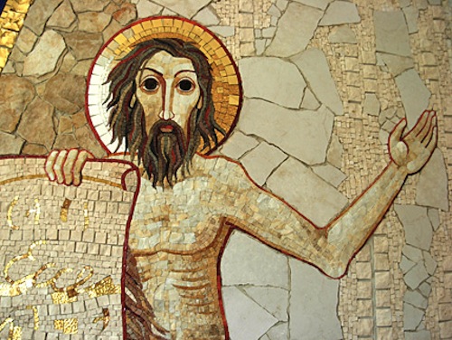 man standing near cross during night